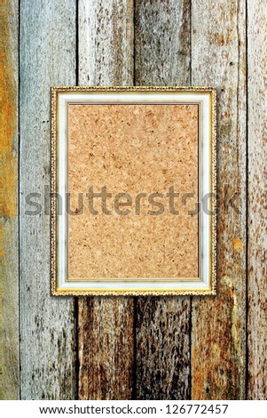 The old photo frame on wooden background