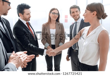 Businesswoman and man shaking hands in the office