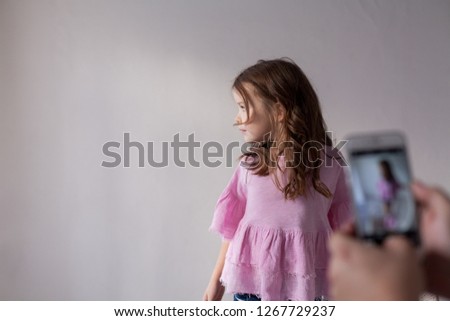 Portrait of beautiful fashionable little girl posing