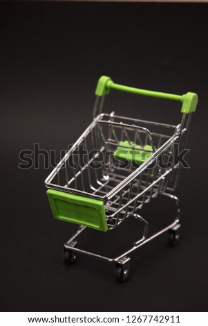 toy shopping carts on black background