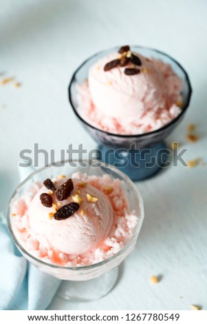 Delicious bowl of strawberry ice cream with raisins.