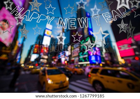 Happy New Year banner hanging with sparkling stars above the bright neon lights of Times Square, New York City