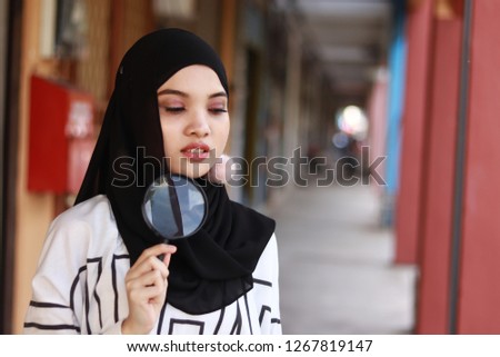 Asian women portraiture. Hijab Fashion. Search concept. Magnifying glass.