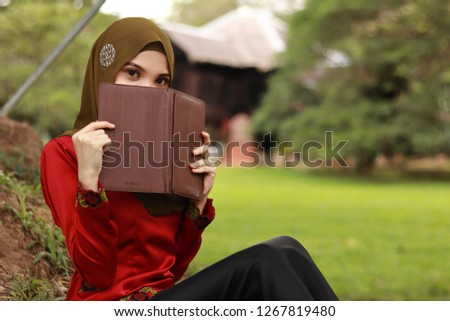 Cute women with books. education concept in the nature. Beautiful women with Asian hijab fashion portraiture.