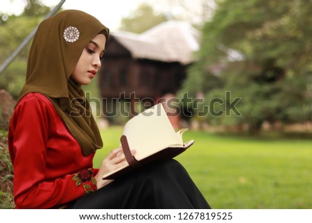 Cute women with books. education concept in the nature. Beautiful women with Asian hijab fashion portraiture.