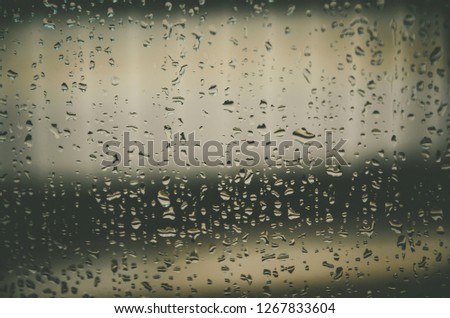 Wallpaper of rain drops or water drops on the glass, Vintage background by rainy drop on window, Rainy day with raindrop on the glass, Texture of water droplet on window glass.
