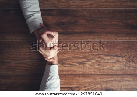 couple hands compete on table