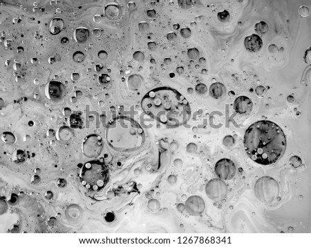abstract art background.oil and water.Free movement of white and black.The texture of the surface is mixed with water and acrylic and oil. The abstract image is in the form of free white and black.