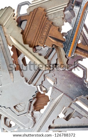 Detailed shot of old fashioned metallic keys on plain white background.