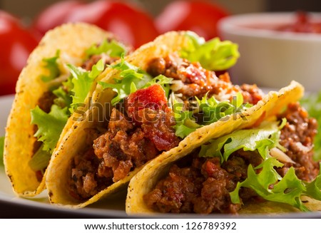plate with taco and fresh tomatoes