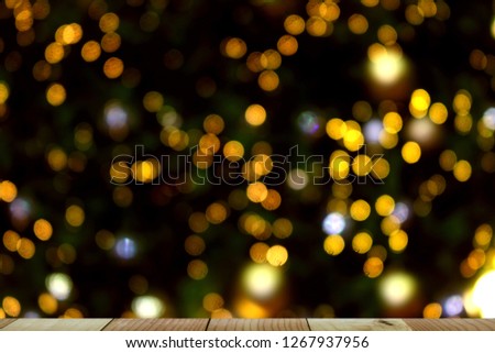 wooden table of free space for your product and xmas tree blurred background 