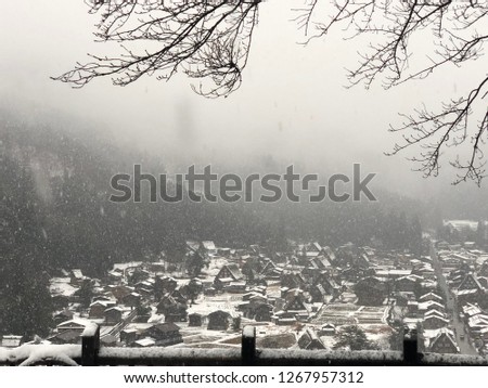 Winter snow falls in the middle of the valley village.