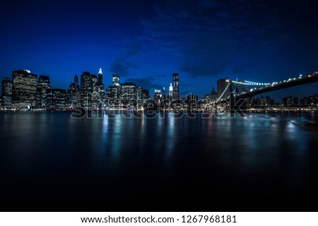 Brooklyn Bridge and Manhattan view. Panorama of New York city at night from Brooklyn. 