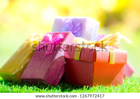 Gift box on green grass background with as a present for Christmas, new year, valentine day or anniversary.