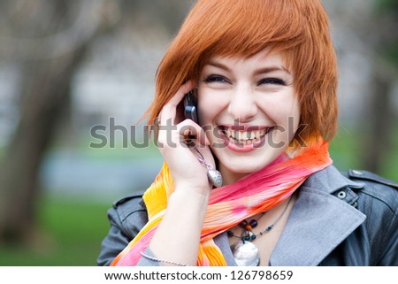 Young woman talking on mobile phone on the street Royalty-Free Stock Photo #126798659