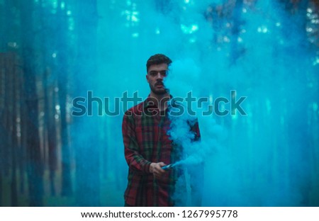 the guy in the smoke, beautiful smoke, a picture in the forest. colorful smoke.