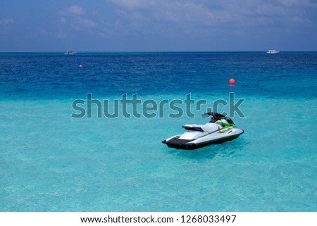 Blue sea and a jet ski floating on the sea, Water motorcycle in the blue sea on clear sunny day, Water bike on waves , Beautiful Turquoise Water of  Sea and Jet Ski Waiting
