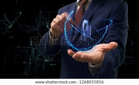 Businessman shows concept hologram 3d pocket camera on his hand. Man in business suit with future technology screen and modern cosmic background