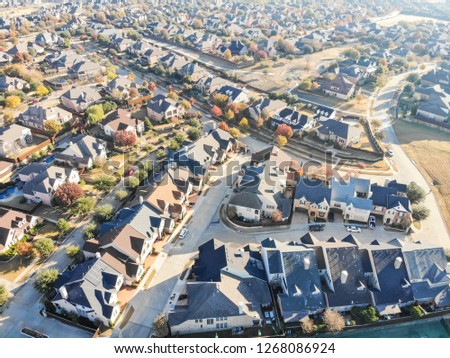 Top view well lined and branched of single-family detached homes in park side Cedar Hill, a city in Dallas and Ellis counties, 16 miles southwest of downtown Dallas. Color autumn leaves