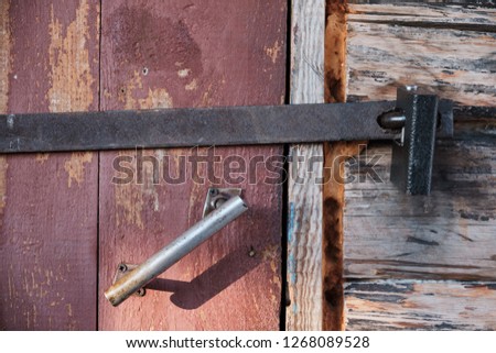 the old wooden door closed on the lock