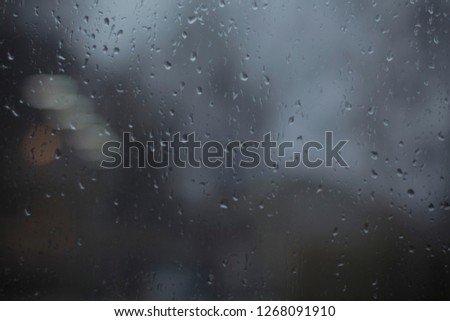 Drops on the glass, background, rain outside the window, cover, picture and photo for you. warm colors.