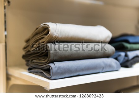 sale, shopping, fashion, style concept - Stack of chino pants , Light gray , gray , light blue color, in the shopping mall.