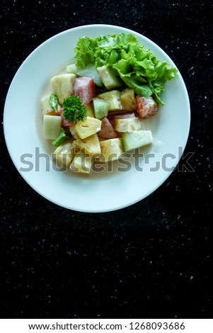 A Plate of Fruit Salad with Mayonnaise 