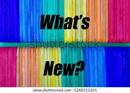 Colorful wooden or ice cream stick and words WHAT'S NEW? with selective focus. Business and education concept