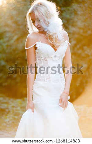 Beautiful bride in sunset rays