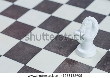 white horse figure on a chessboard
