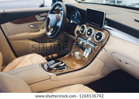 Car modern interior with white leather seats vehicle. Royalty-Free Stock Photo #1268136742