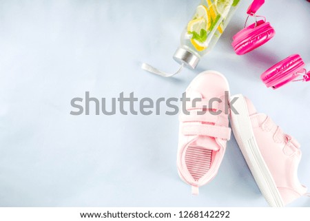 Sport and fitness creative layout, dumbbells, women's sneakers, jump rope, notebook, bottle with detox water with lemon and mint, bright trendy background, top view,  creative layout copy space