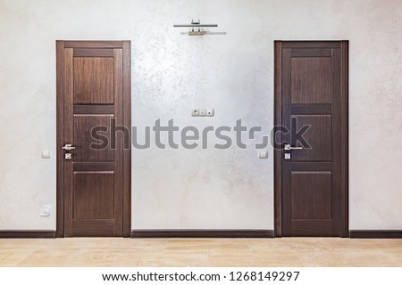 Two doors in the corridor of the luxury rich apartments. Royalty-Free Stock Photo #1268149297
