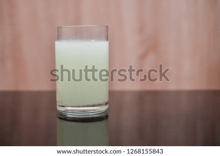 effervescent tablet dissolves in a glass of water on a black table