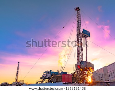 Drilling a deep well with a drilling rig in an oil and gas field. The field is located in the Far North beyond the Arctic Circle. The shooting took place in the winter on a polar day. Royalty-Free Stock Photo #1268161438