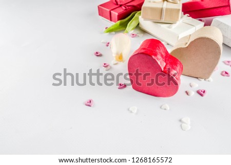 Valentines day gifts boxes background, frame for holiday greeting card background, with confetti  candy hearts, flat lay, top view, copy space