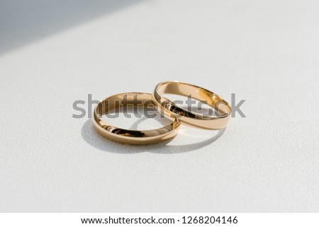 gold wedding rings on a white background Royalty-Free Stock Photo #1268204146
