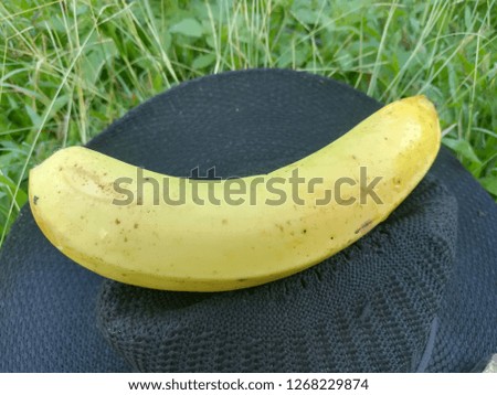 Bananas and black hat placed on the lawn