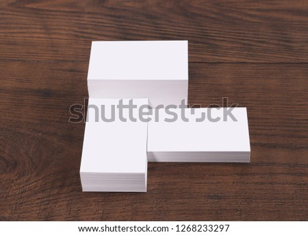 Mock up of business cards on wood background.
