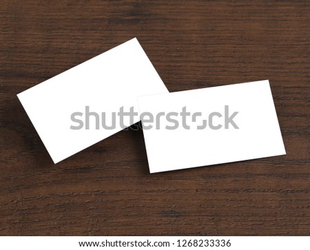 Mock up of business cards on wood background.
