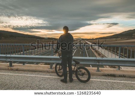 Young man riding a bmx.BMX rider bike. Extreme urban sports