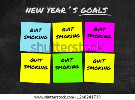 handwritten 2019 New Year resolutions and goals in sticky notes in commitment determination about quit smoking giving up cigarettes and tobacco isolated on blackboard background
