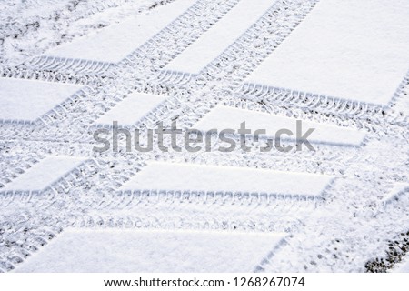 Car tire tracks in fresh snow