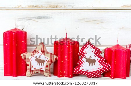 Christmas Card with Red Candles on a White Wooden Background