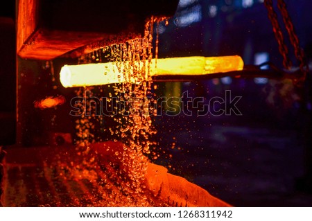 The process of forging metal in the production of heavy molded metal products. Blacksmithing. Pattern and forms for the artist blacksmith. Treatment of molten metal close-up. Handmade blacksmith Royalty-Free Stock Photo #1268311942
