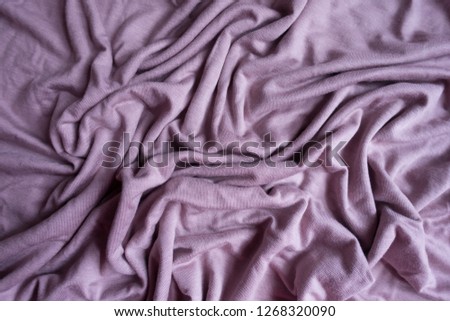 Crumpled simple pink viscose fabric from above