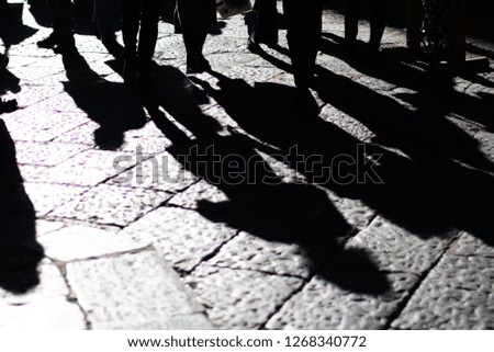 Hard Shadows Of People On Cobblestone Streets In Naples Italy In Early Morning During The Winter