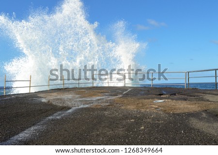 Pier in Atlantic Ocean that breaks water