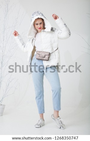 Beautiful model posing in white a downcoat