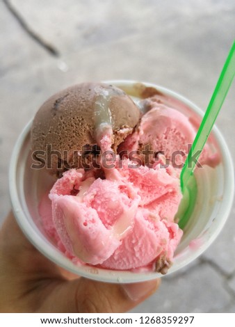 Chocolate and strawberry ice cream in a cup.
